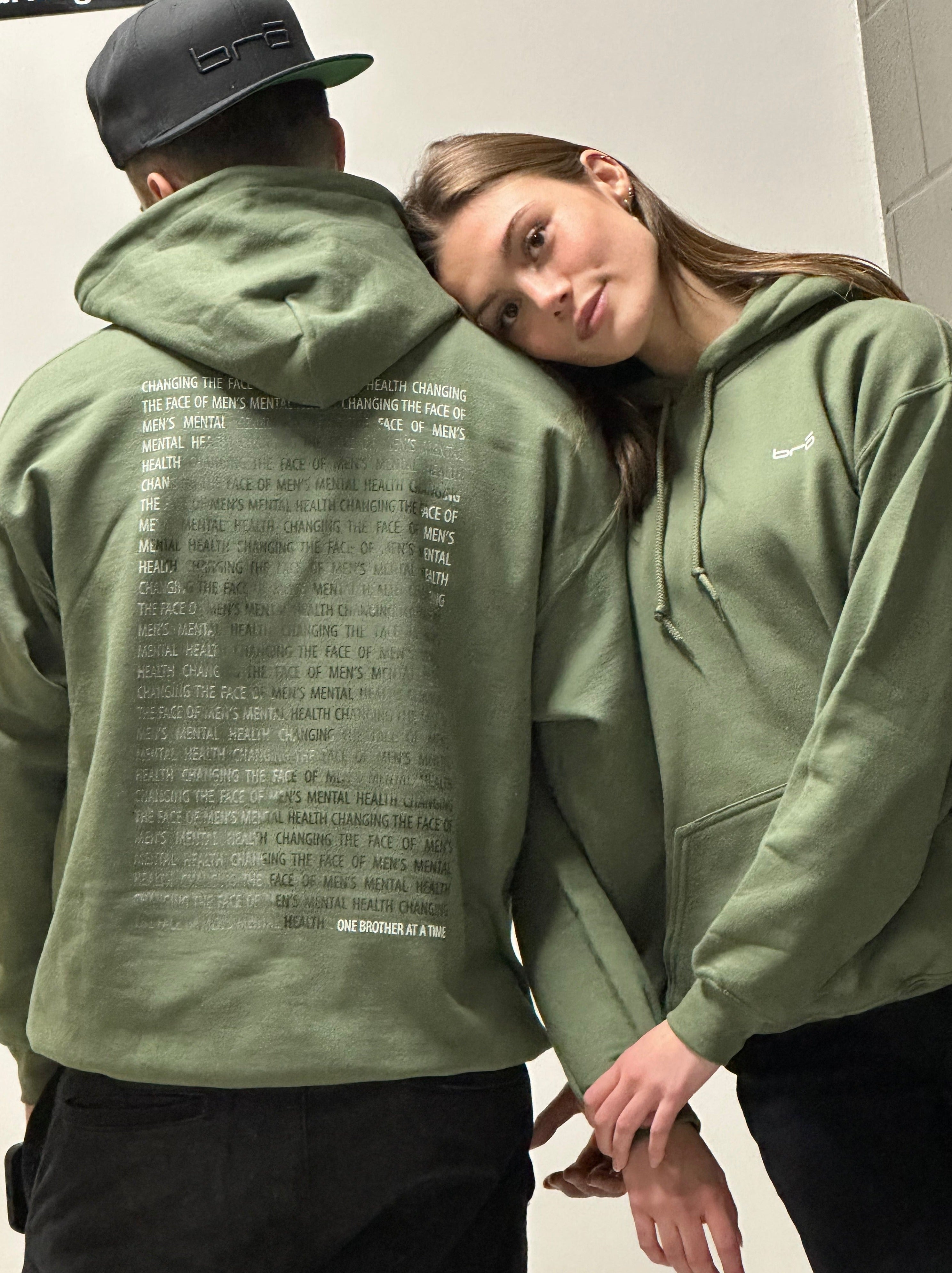 Couple wearing green hoodie
